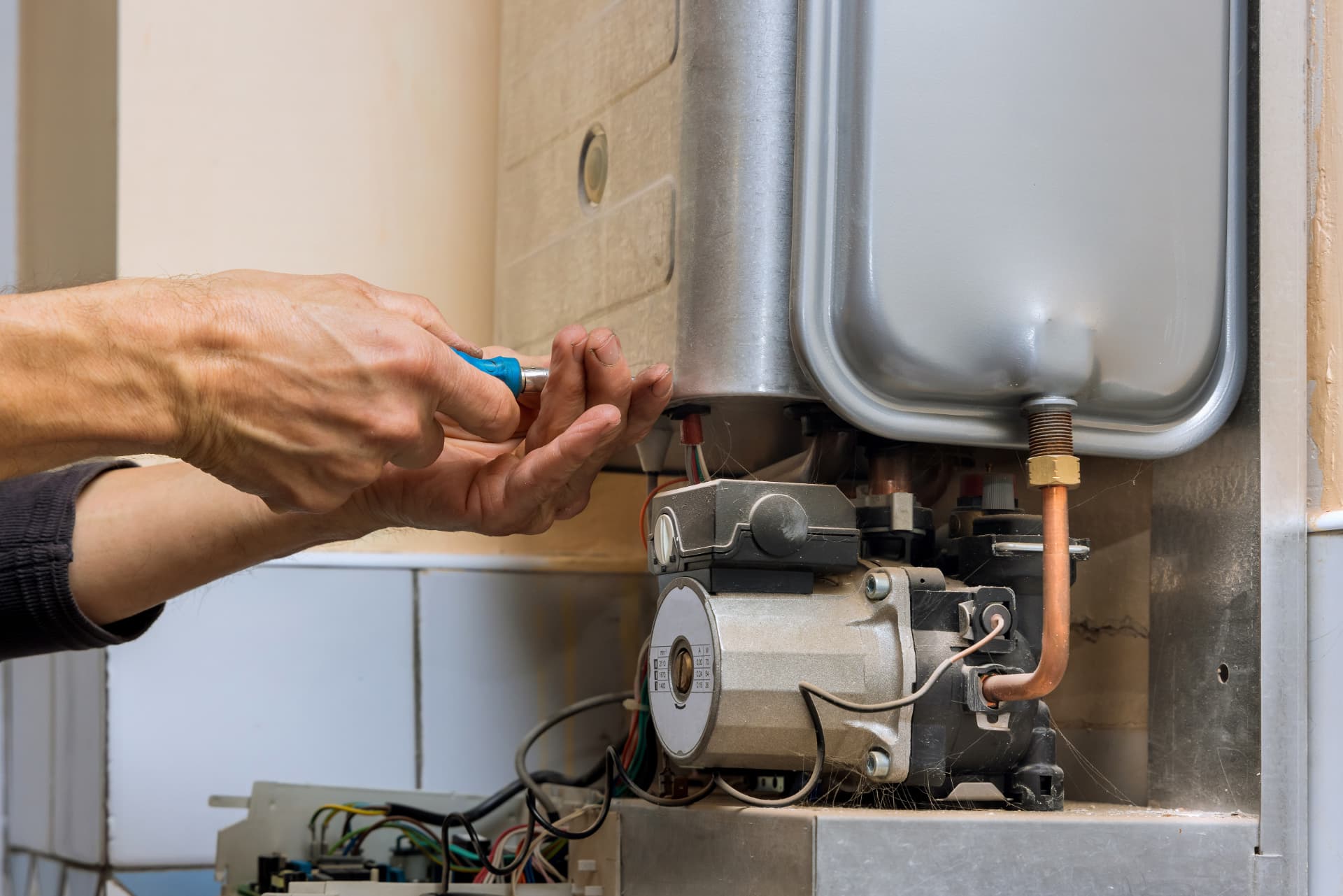 Heating engineer servicing a gas boiler
